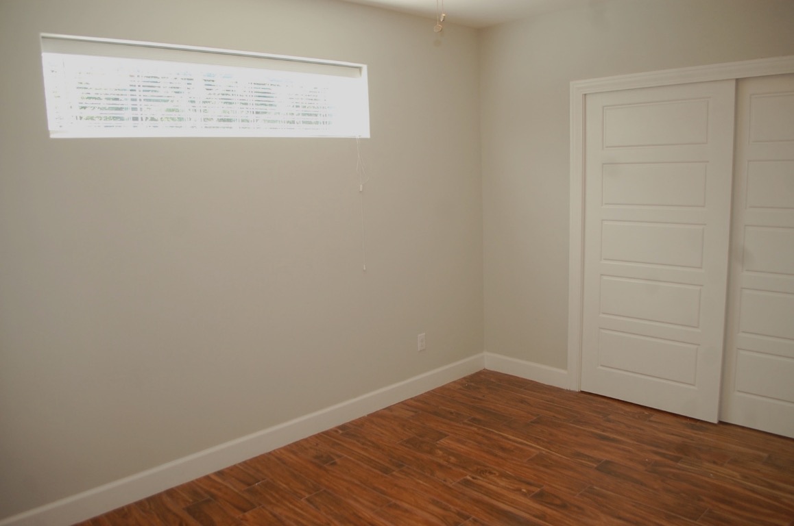 1707 Garden Street, Unit B Austin, TX 78702 - Photo 8 of 33 Spare room with baseboards and dark wood-style floors