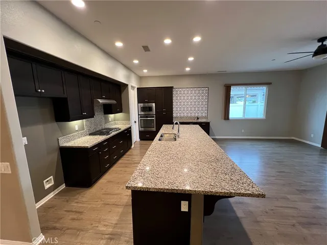 a kitchen with sink and refrigerator