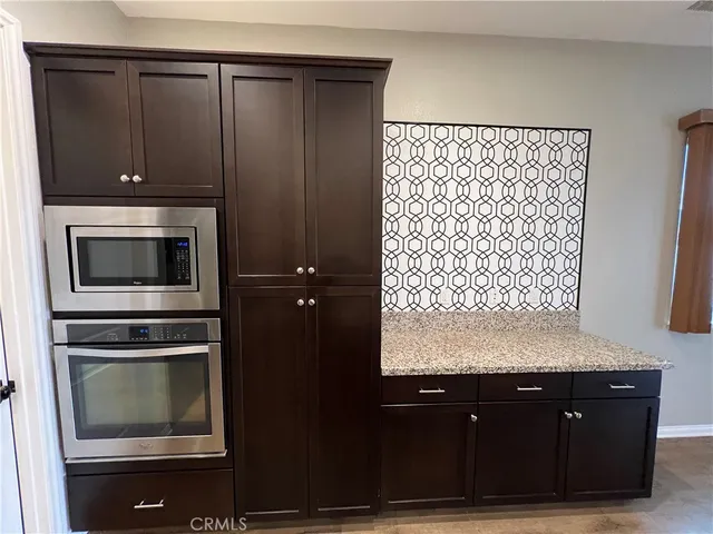 a kitchen with a refrigerator and a stove