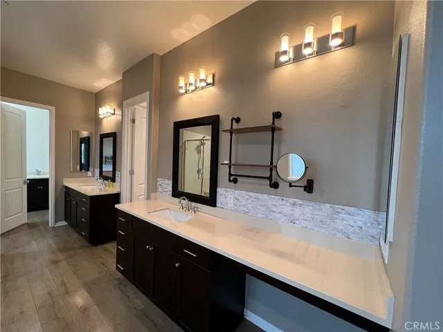 a bathroom with a sink double vanity and a mirror
