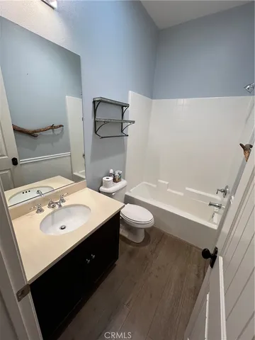 a view of a patio with table and chairs under an umbrella