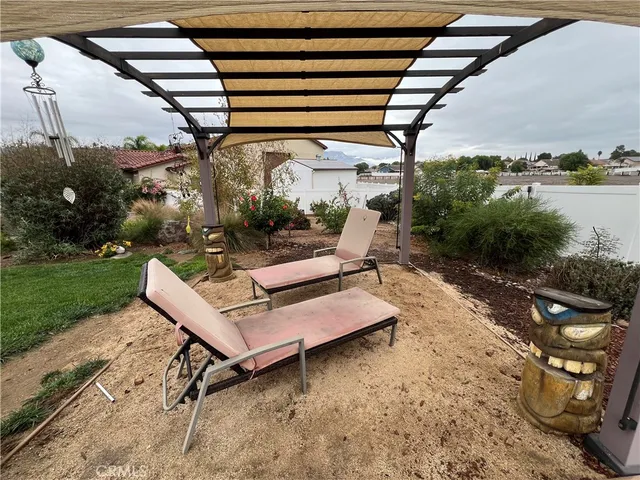 a view of a backyard with sitting area