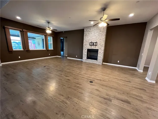 a view of an empty room with a fireplace and a window