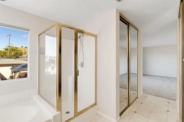a bathroom with a shower and a glass door