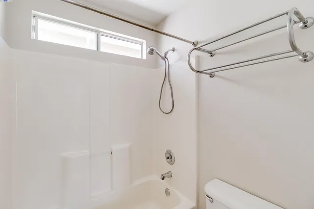 a bathroom with a shower and a toilet