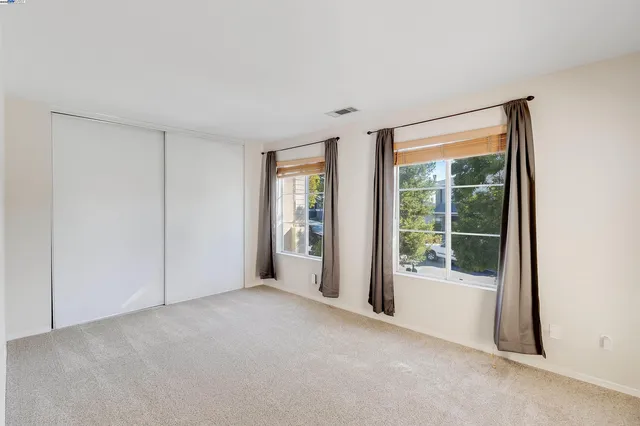 a view of an empty room with glass door