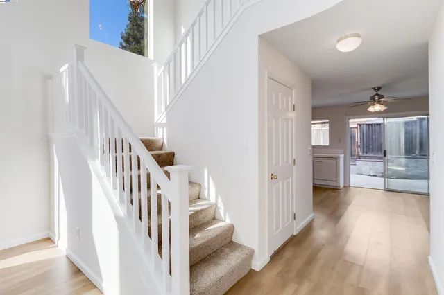 a view of a hallway with wooden floor and entryway