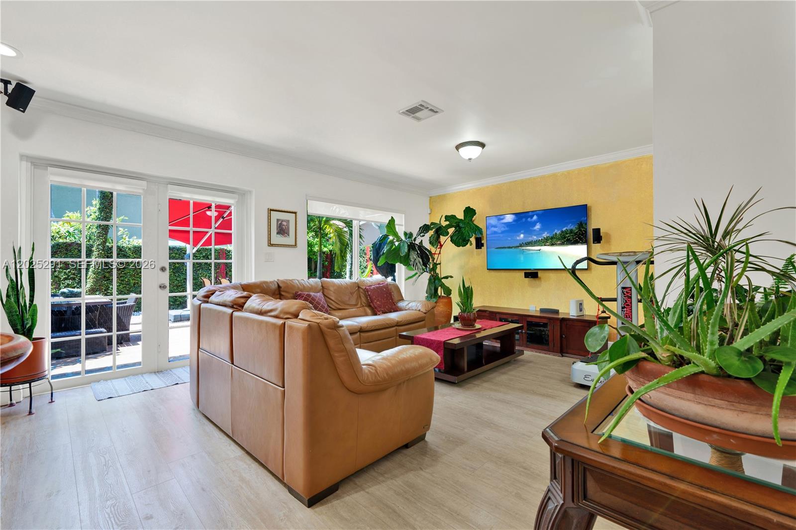 10006 Southwest 162nd Path Miami, FL 33196 - Photo 12 of 40 a living room with furniture a floor to ceiling window and potted plant