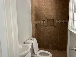 a white toilet sitting next to a bathroom sink