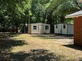 a view of a white house with a yard