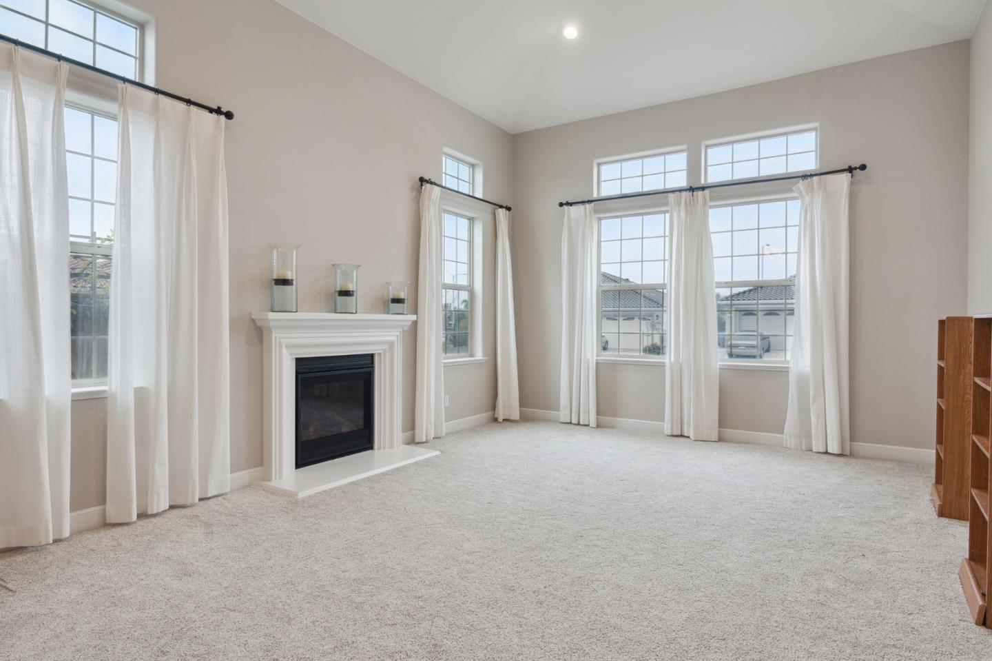 1471 Trinity Circle Hollister, CA 95023 - Photo 4 of 29 a view of an empty room with a fireplace and a window