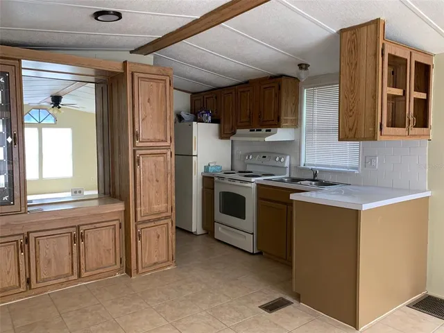 a kitchen with a sink appliances and cabinets