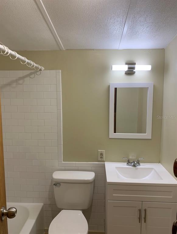 3000 Clarcona Road, Unit 723 Apopka, FL 32703 - Photo 5 of 14 a bathroom with a toilet a sink and mirror