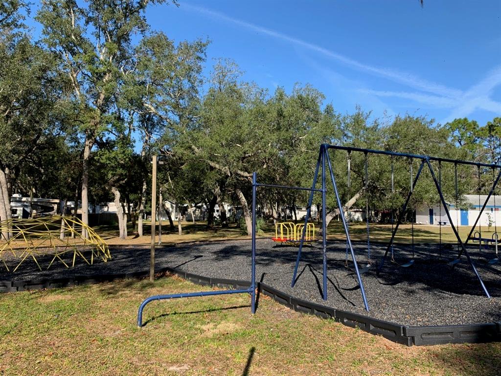 3000 Clarcona Road, Unit 723 Apopka, FL 32703 - Photo 10 of 14 a view of swimming pool with outdoor seating and trees in the background