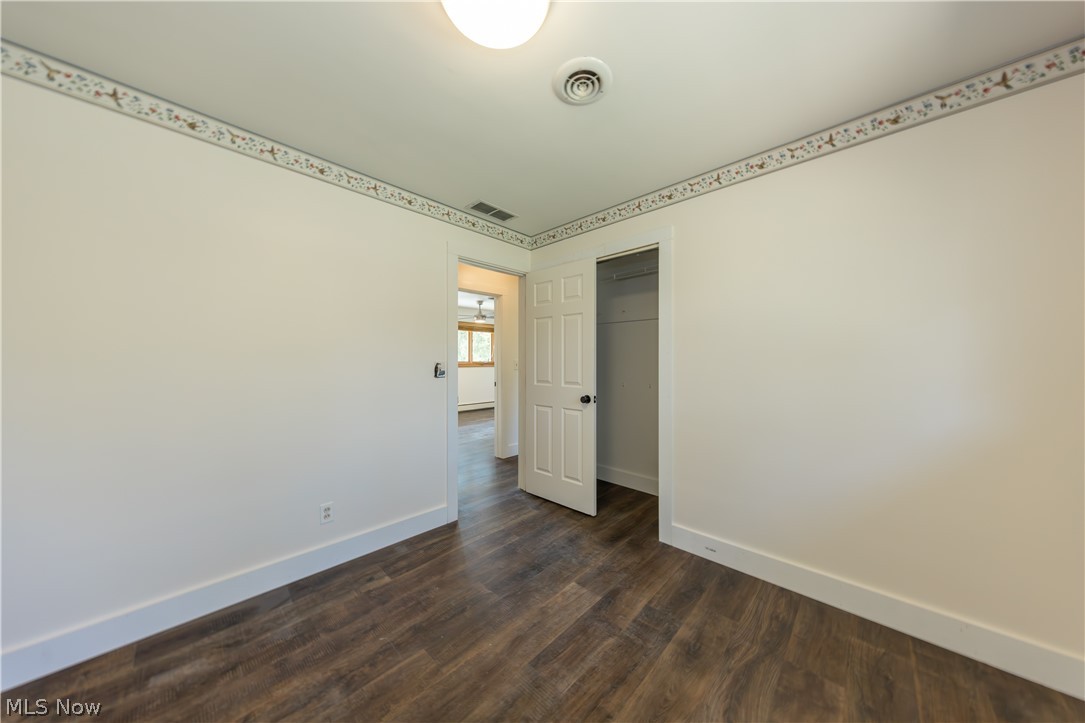 7969 Dines Road Novelty, OH 44072 - Photo 30 of 48 Bedroom featuring wood-finish flooring, white baseboards, and neutral wall tones