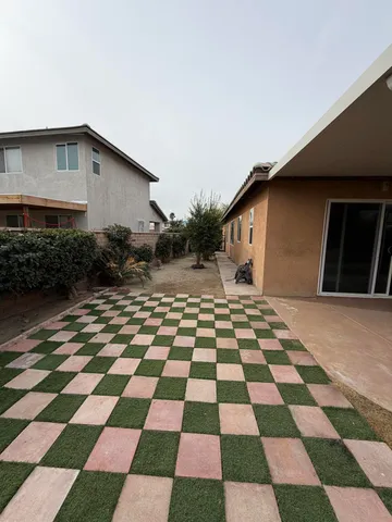 an aerial view of a house with a yard and potted plants