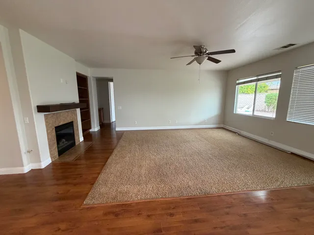 wooden floor in an empty room with a fireplace