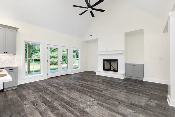 a view of empty room with a fireplace and a window