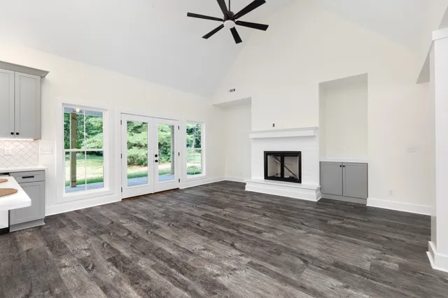a view of empty room with a fireplace and a window