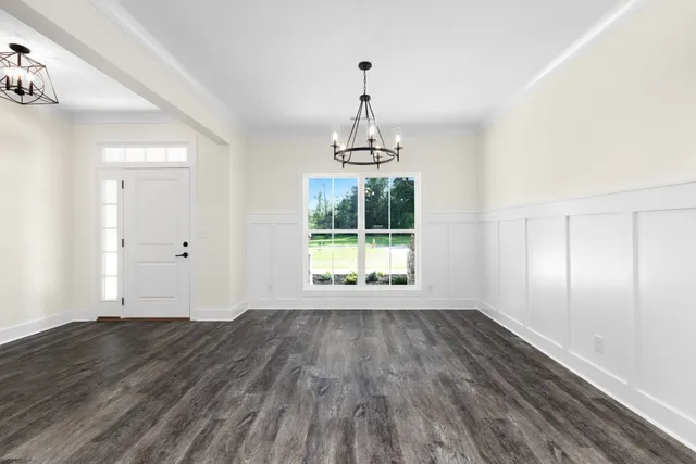 a view of wooden floor and windows in a room