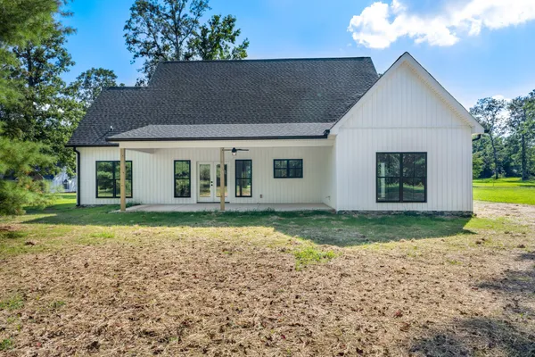 a front view of a house with a garden and yard