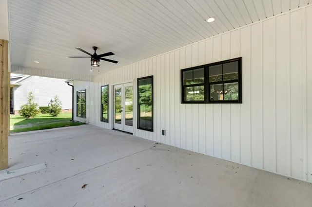 a view of a livingroom with a ceiling fan and window