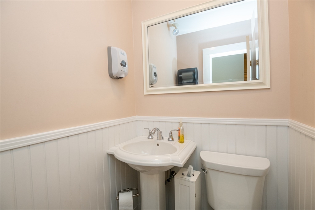 11 Linden Street Reading, MA 01867 - Photo 11 of 31 a bathroom with a sink a toilet and mirror