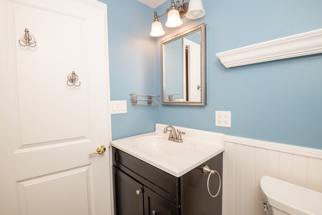 11 Linden Street Reading, MA 01867 - Photo 22 of 31 a bathroom with a sink a toilet and a mirror