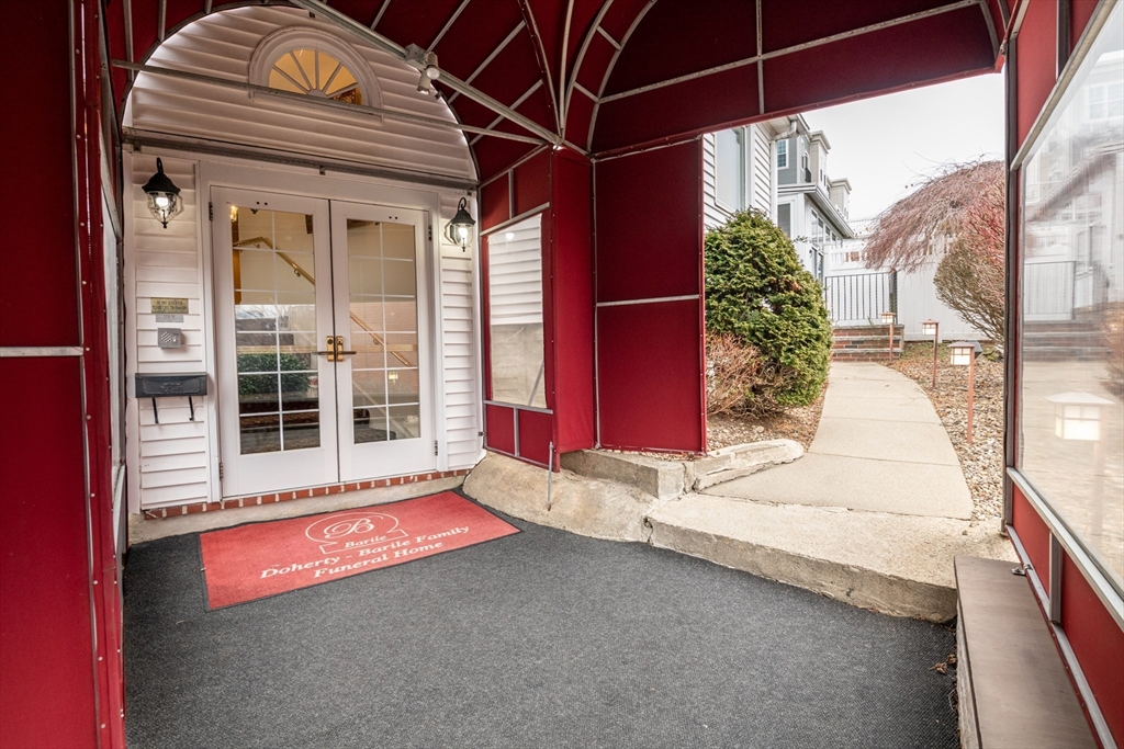 11 Linden Street Reading, MA 01867 - Photo 4 of 31 a front view of a house with a garage