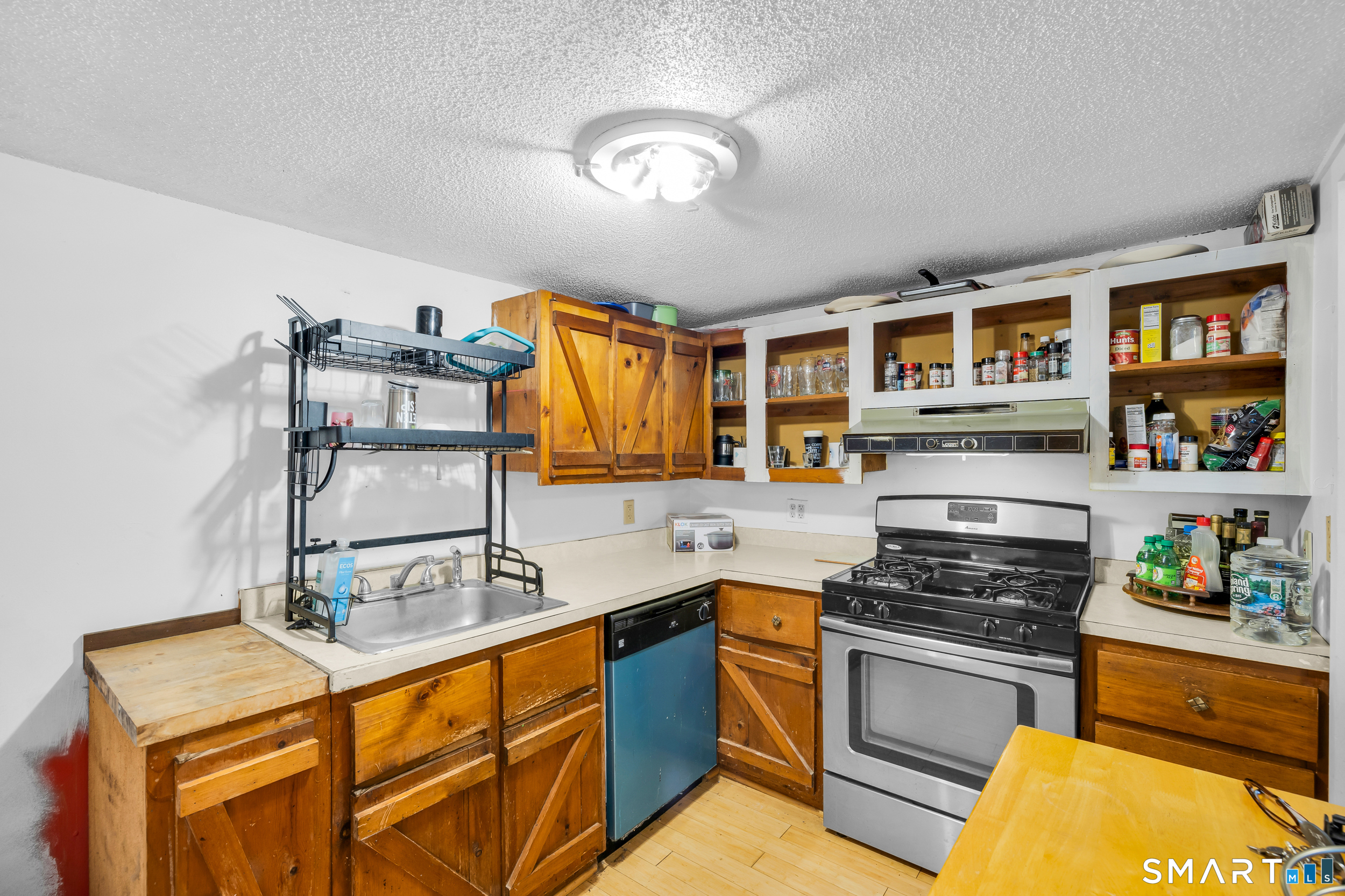 90 Rowley Road Woodbury, CT 06798 - Photo 12 of 40 a kitchen with stainless steel appliances granite countertop a stove and cabinets
