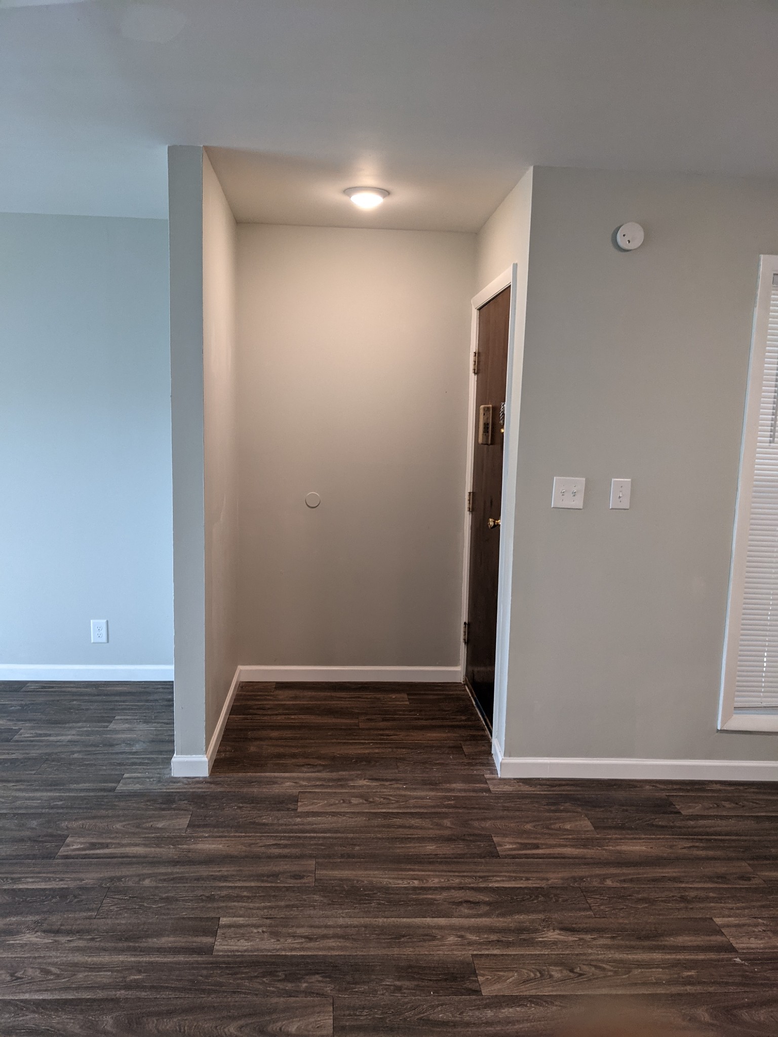 320 Welch Road, Unit F1 Nashville, TN 37211 - Photo 4 of 13 a view of an empty room with wooden floor and a window