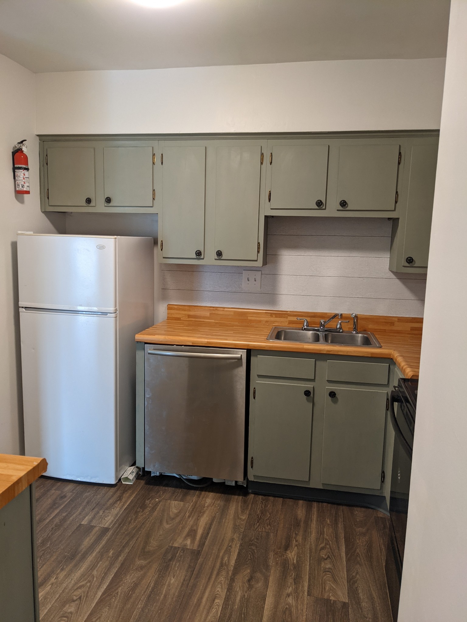 320 Welch Road, Unit F1 Nashville, TN 37211 - Photo 6 of 13 a kitchen with wooden cabinets and a refrigerator