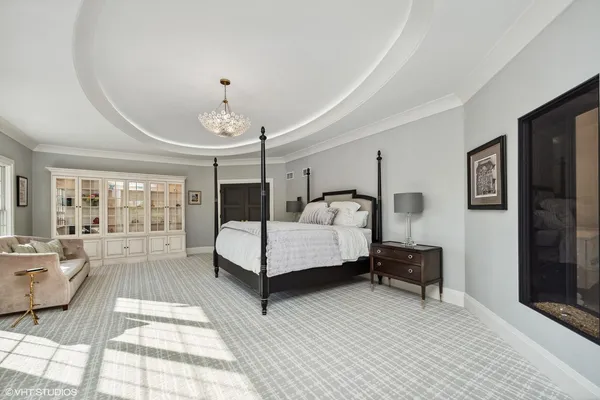 a large white room with a large mirror vanity and a sink