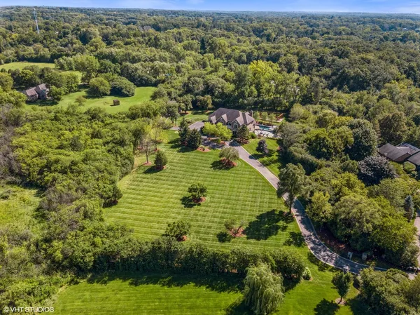 a view of a park with iron fence