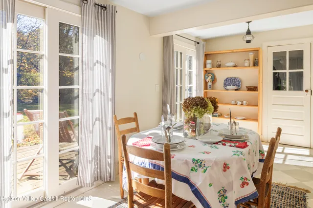 a room with painting on the wall and a window