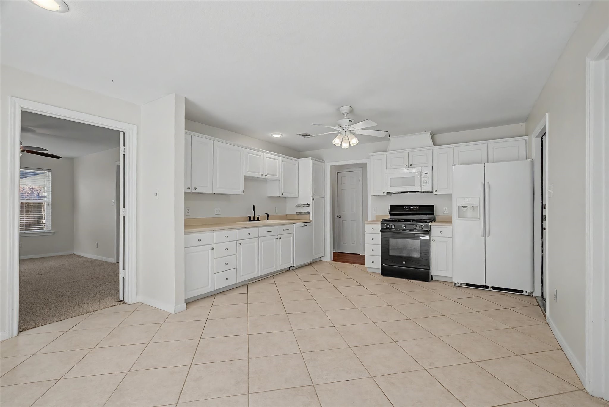 413 Farrer Street Angleton, TX 77515 - Photo 17 of 43 a kitchen with stainless steel appliances a refrigerator sink and cabinets