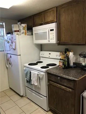 a kitchen with stainless steel appliances granite countertop a stove and a microwave