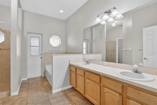 a spacious bathroom with a double vanity sink and a mirror