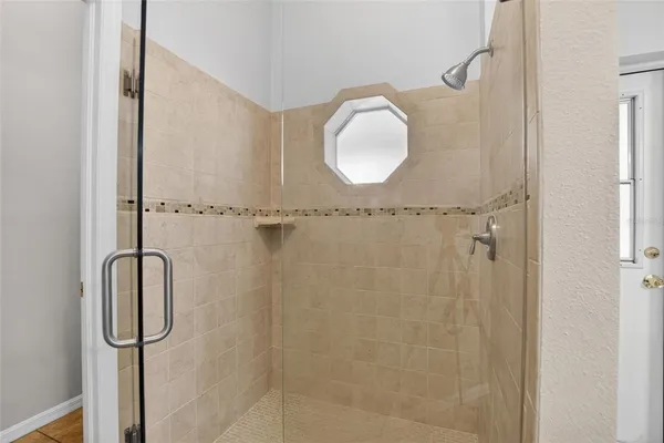 a bathroom with a granite countertop shower mirror and vanity