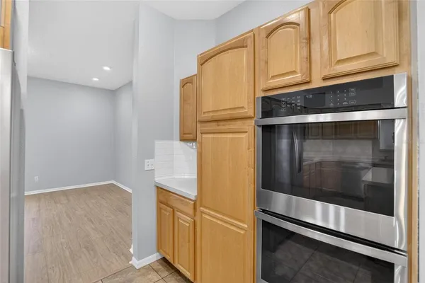 a kitchen with stainless steel appliances granite countertop a refrigerator and a stove top oven