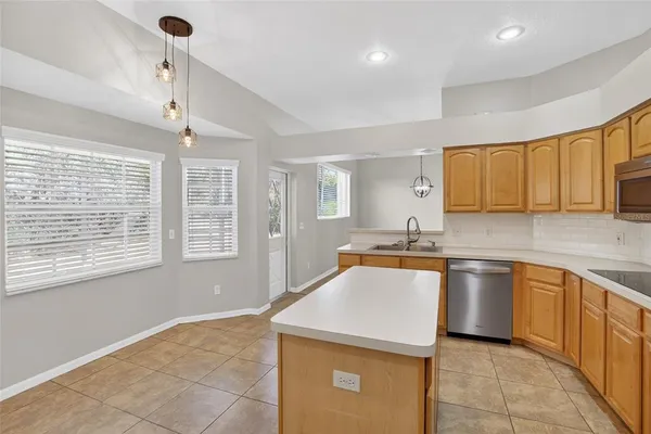 a kitchen with stainless steel appliances granite countertop a sink stove and cabinets