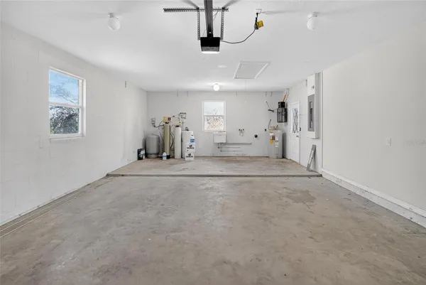 a view of a livingroom with chandelier furniture and windows