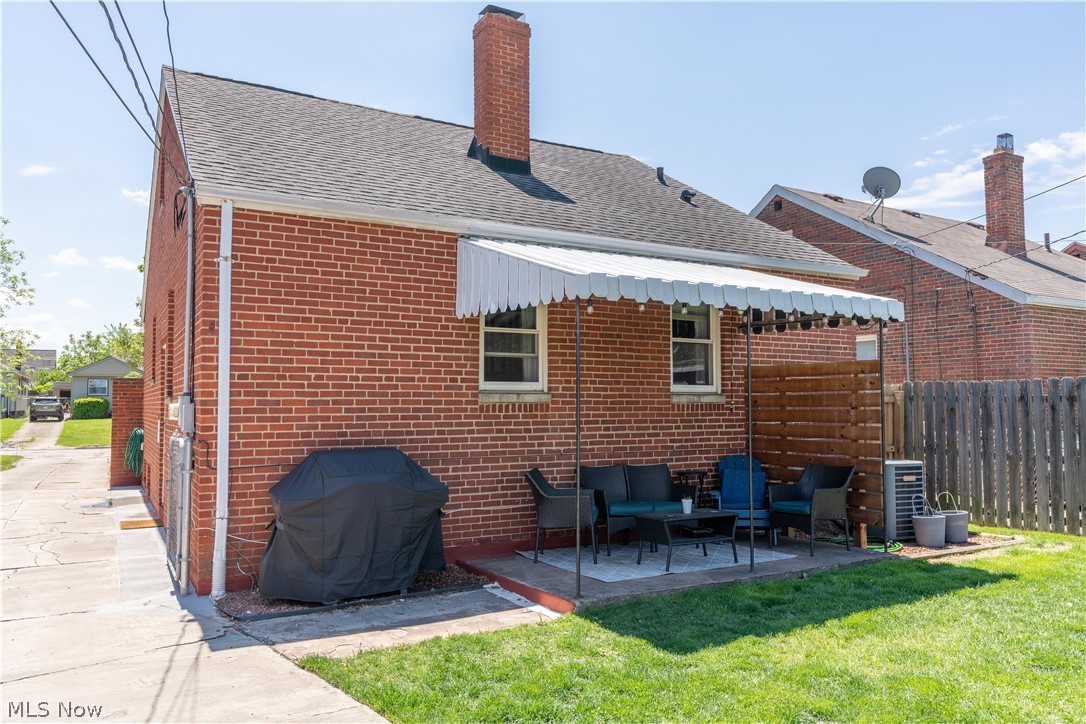 8320 Ackley Road Parma, OH 44129 - Photo 29 of 36 Rear view of house with an outdoor living space, central AC unit, and a patio