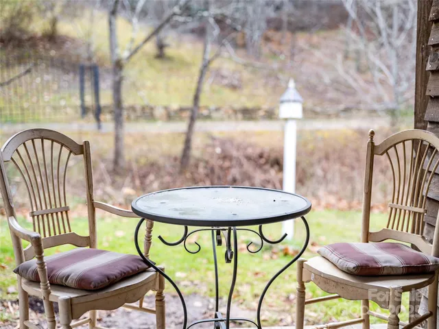 a view of a chairs and table in back