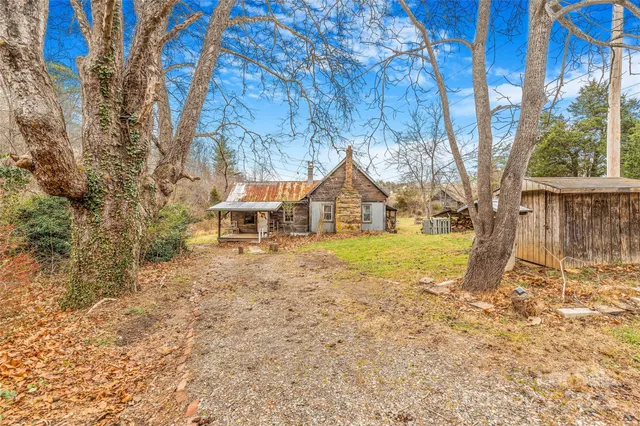 a view of house with backyard