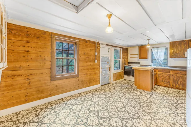 a view of a kitchen with a sink and cabinets