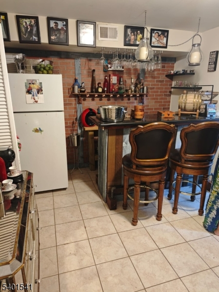 353 Adams Street Newark, NJ 07114 - Photo 13 of 15 a kitchen with a stove and a refrigerator