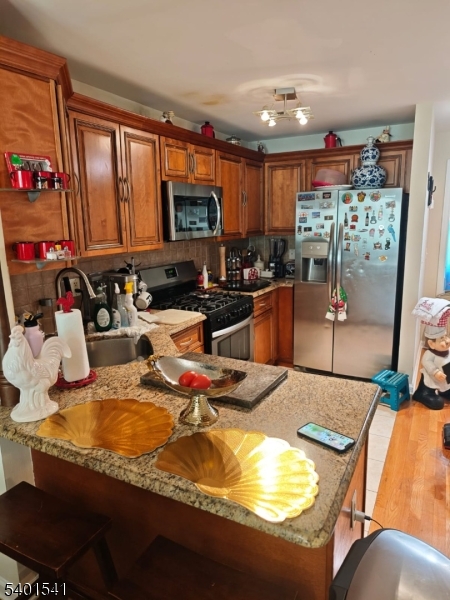 353 Adams Street Newark, NJ 07114 - Photo 7 of 13 a room with furniture and a flat screen tv