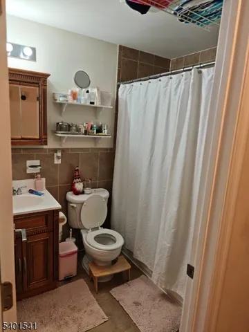 a bathroom with a toilet a sink and a shower