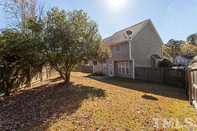 a front view of a house with a yard covered in snow